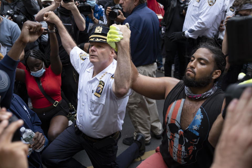 Chief of Department of the New York City Police, Terence Monahan, takes a knee with activists as protesters paused while walking in New York, Monday, June 1, 2020. Police officials in New York City and elsewhere say recent shootings has shown there are consequences to some police reforms they see as misguided. Emboldened criminals feel "that the cops can’t do anything anymore, that no one likes the police, that they can get away with things, that it’s safe to carry a gun out on the street,” Monahan said. (AP Photo/Craig Ruttle)