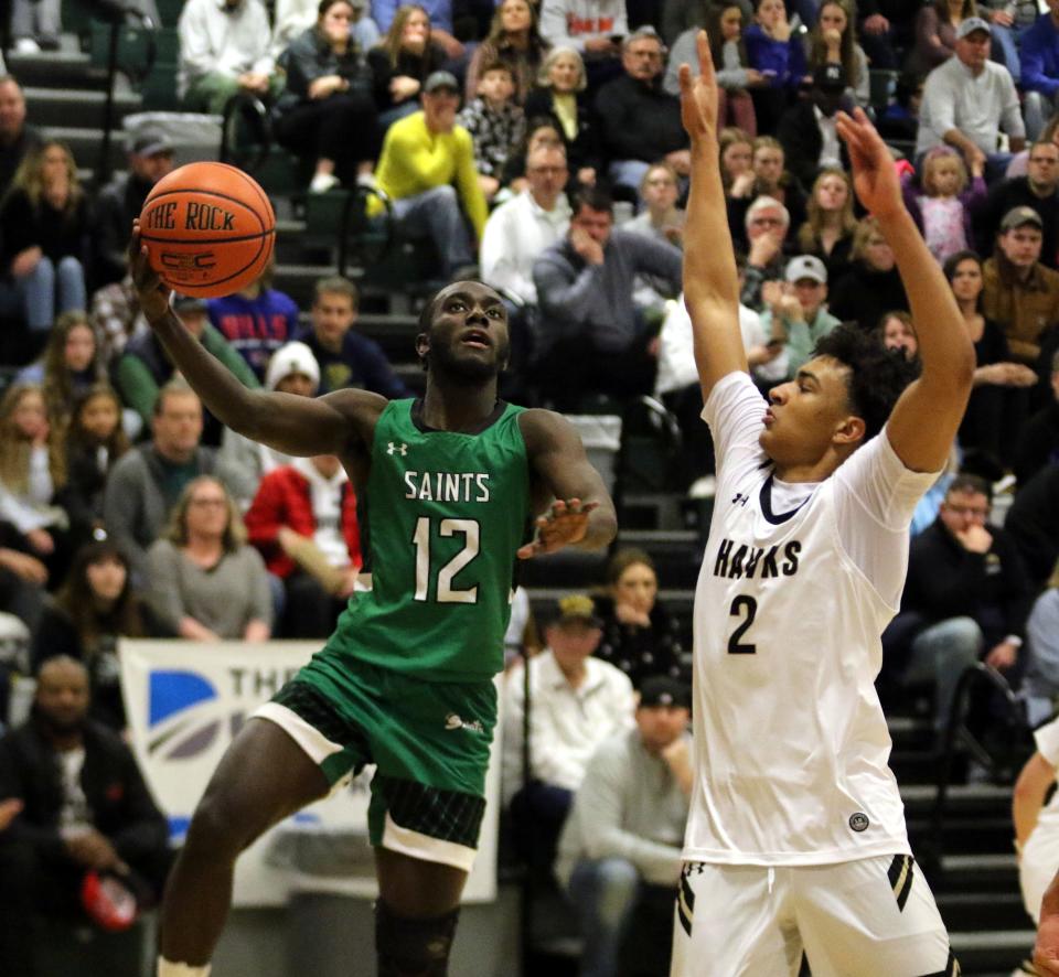 Binghamton Seton Catholic Central's Yusri Razzag looks for his shot as Corning's Isaiah Henderson defends during the Hawks' 74-63 overtime win in the Boys Regional Division 2 championship game at the Josh Palmer Fund Clarion Classic on Dec. 30, 2022 at Elmira High School.