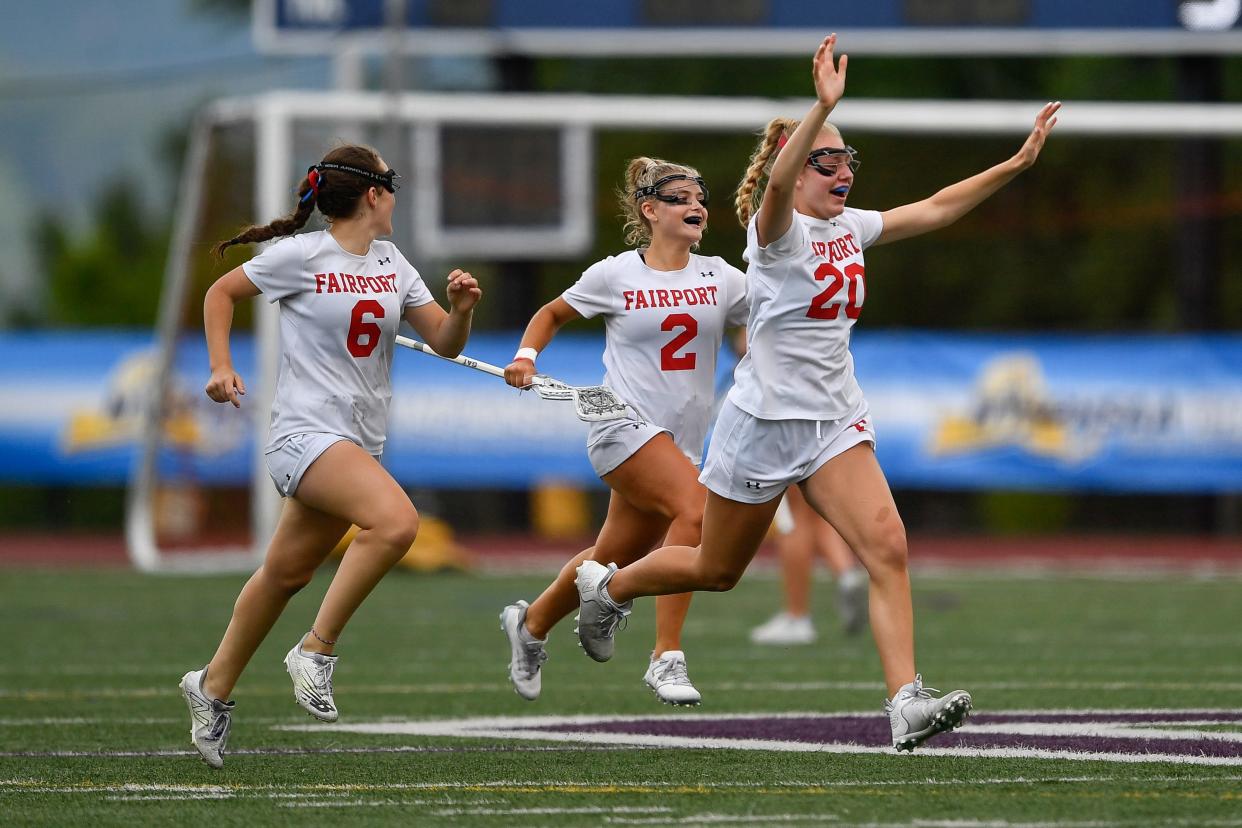 Fairport players Ella Peers, left, Ava Peers and Ellie Miller celebrate their win against Suffern in a NYSPHSAA Girls Lacrosse Championships Class A semifinal in Cortland, N.Y., Friday, June 9, 2023. Fairport advanced to the Class A final with an 8-7 win over Suffern.