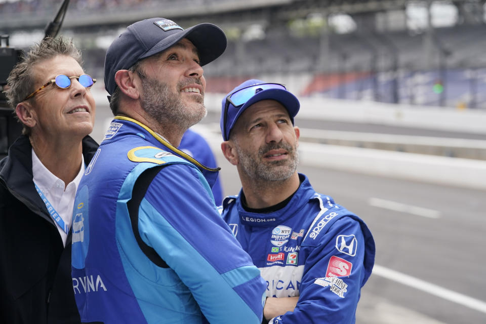 Jimmie Johnson, center, and Tony Kanaan, right, of Brazil, look at the speeds during practice for the Indianapolis 500 auto race at Indianapolis Motor Speedway, Sunday, May 22, 2022, in Indianapolis. (AP Photo/Darron Cummings)