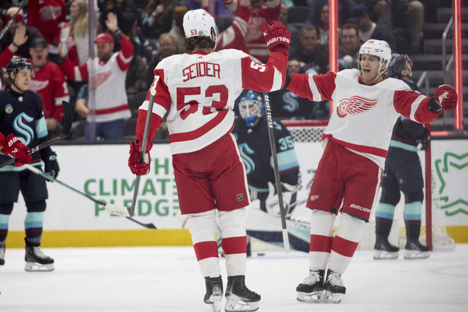 Detroit Red Wings defenseman Moritz Seider celebrates his goal with right wing Patrick Kane, right, against the Seattle Kraken during the first period of an NHL hockey game, Monday, Feb. 19, 2024, in Seattle. (AP Photo/John Froschauer)