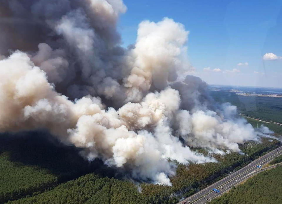 A forest is burning near the highway A9 between Potsdam and Fichtenwalde, eastern Germany, Thursday, July 26, 2018. (Polizei Brandenbur/dpa via AP)