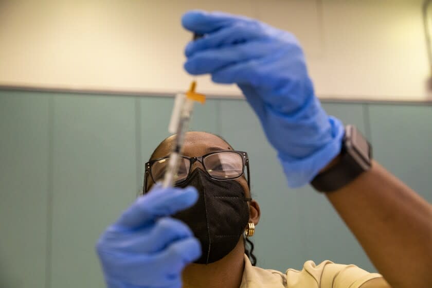 Registered nurse Marcia Reid draws up COVID-19 vaccines at a vaccination clinic hosted by Los Angeles County Public Health at Balboa Sports Complex in Encino, Calif., on Saturday May 21, 2022. COVID-19 booster shots are now available for children ages 5-11 in Los Angeles County and LA County Public Health is encouraging parents to bring eligible children to vaccination sites to get boosted before summer vacation and holiday travel. (Alisha Jucevic/For The Times)