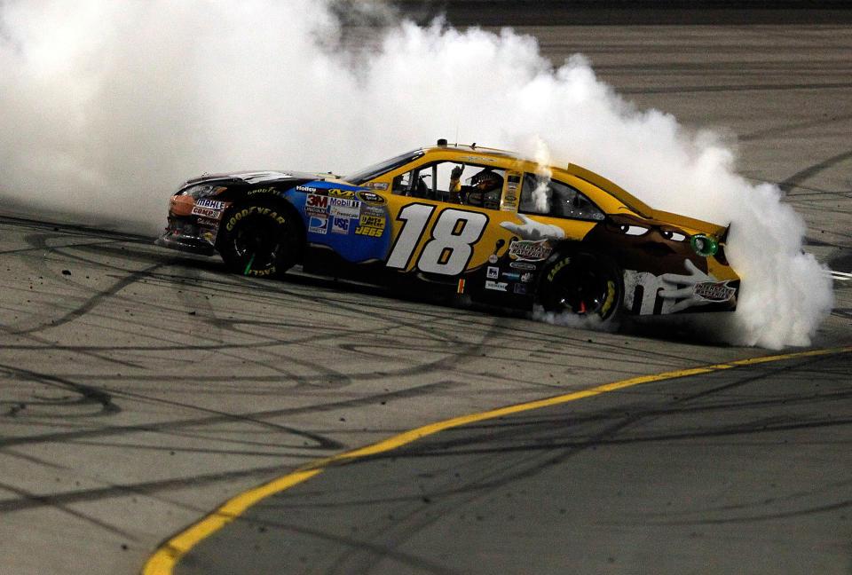 RICHMOND, VA - APRIL 28: Kyle Busch, driver of the #18 M&M's Ms. Brown Toyota, celebrates with a burnout after winning the NASCAR Sprint Cup Series Capital City 400 at Richmond International Raceway on April 28, 2012 in Richmond, Virginia. (Photo by Streeter Lecka/Getty Images)