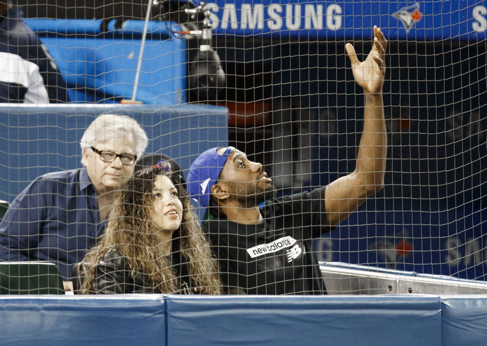 Toronto Raptors' Kawhi Leonard and his girlfriend, Kishele Shipley, watch the Toronto Blue Jays play the Los Angeles Angels during a baseball game Thursday, June 20, 2019, in Toronto. (Mark Blinch/The Canadian Press via AP)