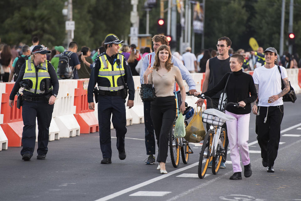 New Year's revelers walk across the Princess Bridge  ahead of the New Year's Eve celebrations in Melbourne.