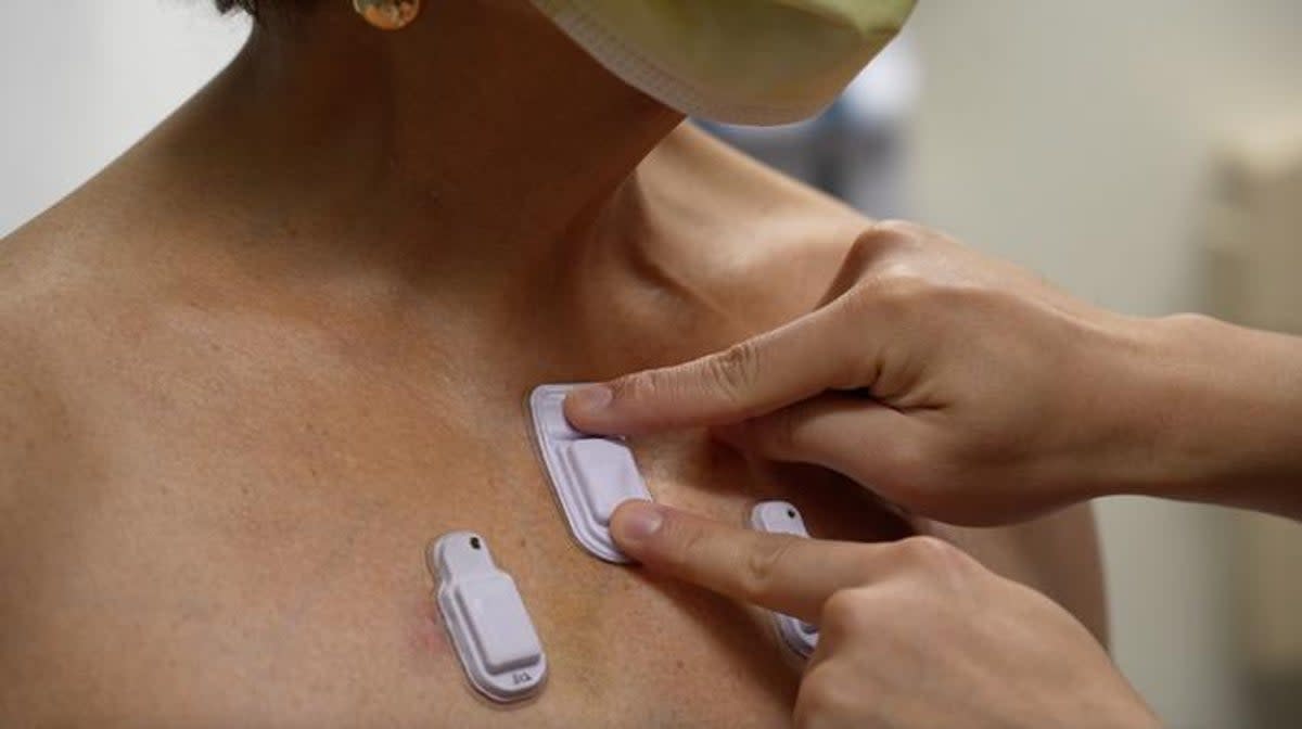 A health care worker places the wearable devices across a patient's chest to capture sounds throughout the lungs that are associated with breathing (Northwestern University)