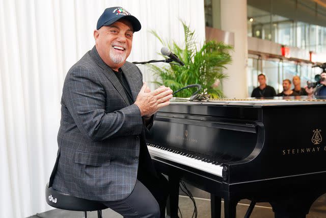 Timothy A. Clary/AFP/Getty Billy Joel poses at the piano after a press conference at Madison Square Garden on July 18, 2018.