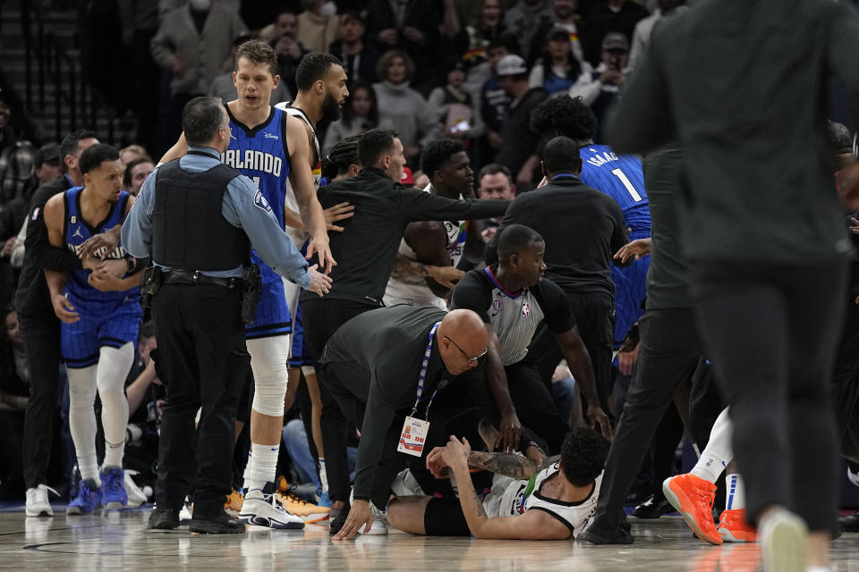 A scrum breaks out between Minnesota Timberwolves and Orlando Magic players during the second half of an NBA basketball game, Friday, Feb. 3, 2023, in Minneapolis. (AP Photo/Abbie Parr)