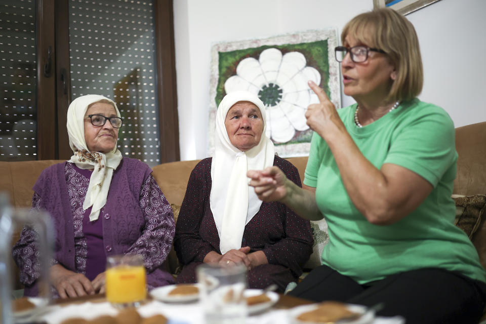 Members of the association Mothers of Srebrenica discuss and watch the United Nations General Assembly session where voting on a draft resolution declaring July 11 the International Day of Reflection and Commemoration of the 1995 genocide in Srebrenica takes place, in Potocari, Bosnia, Thursday, May 23, 2024. (AP Photo/Armin Durgut)