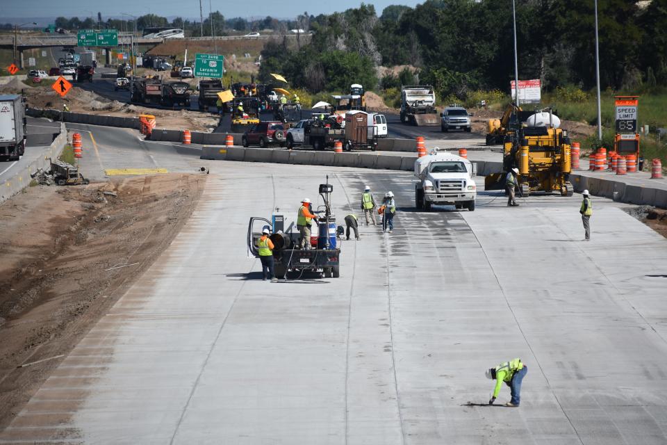 Construction crews work on lanes of the North I-25 Express Lanes project north of Prospect Road in Fort Collins on Monday. The Colorado Department of Transportation says the 19-mile project is 90% complete.