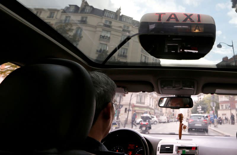 A taxi driver waits for passengers in Paris