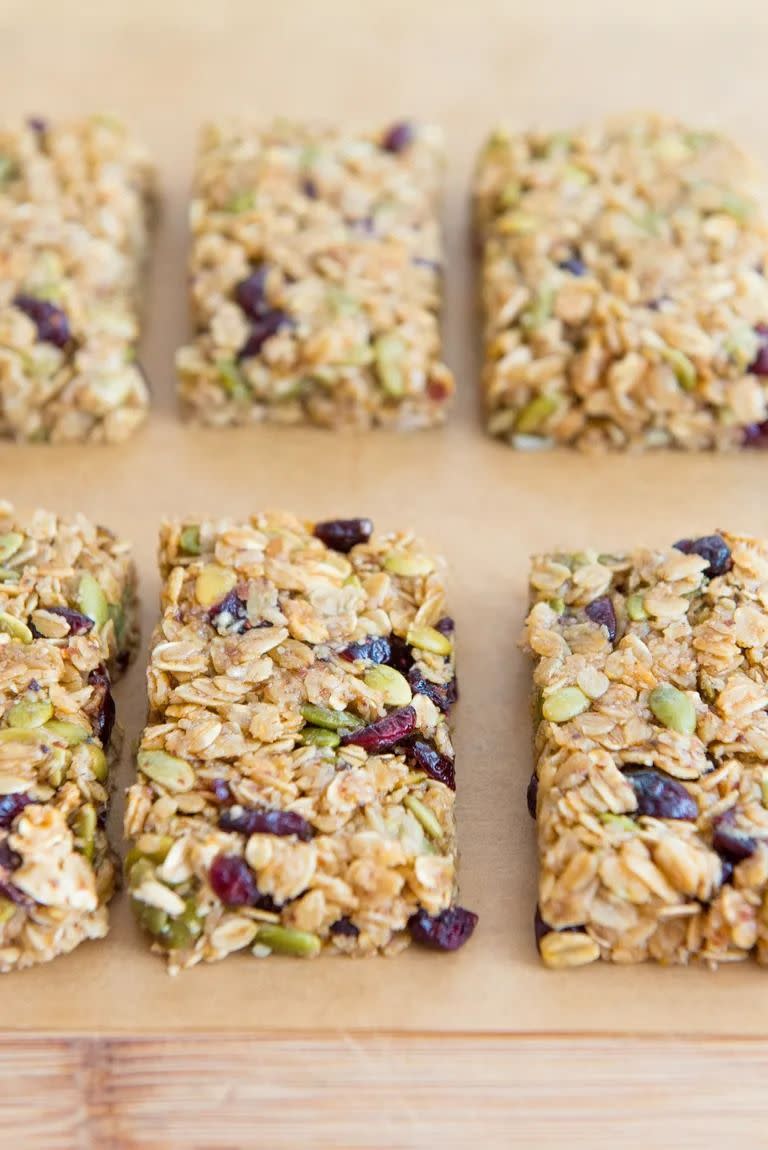 granola bars with seeds and dried cranberries on parchment paper