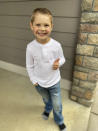 Five-year-old Carver poses for a photo in front of his house on Friday, Sept. 18, 2020 in Scappoose, Oregon. Carver has gained some fame for donating a Baby Yoda toy to Oregon firefighters, who have been posing the tiny green Force user on the fire lines ever since in a journey being documented on a popular Facebook page. (Courtesy of Katie Healey via AP)