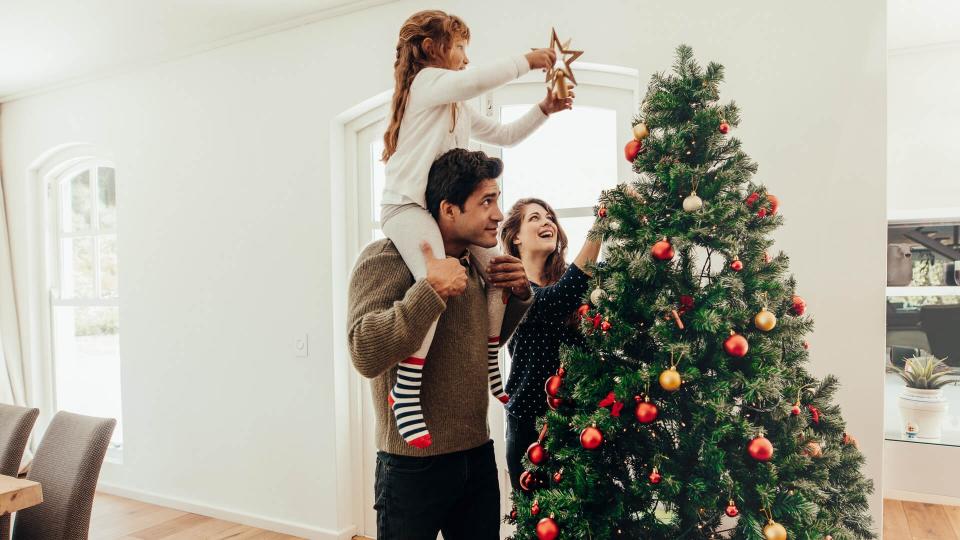 family decorating Christmas tree