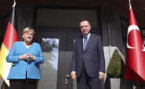 Turkish President Recep Tayyip Erdogan, right, and German Chancellor Angela Merkel pose for photos before their meeting, in Istanbul, Saturday, Oct. 16, 2021. Merkel and Erdogan are expected to discuss Ankara's relationship with Germany and the European Union as well as regional issues including Syria and Afghanistan. The chancellor's trip is one of her last before she leaves her position. (Turkish Presidency Pool via AP)