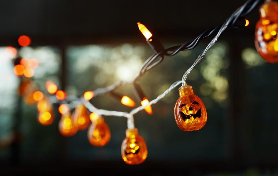 pumpkin electric light string against the window for a Halloween theme