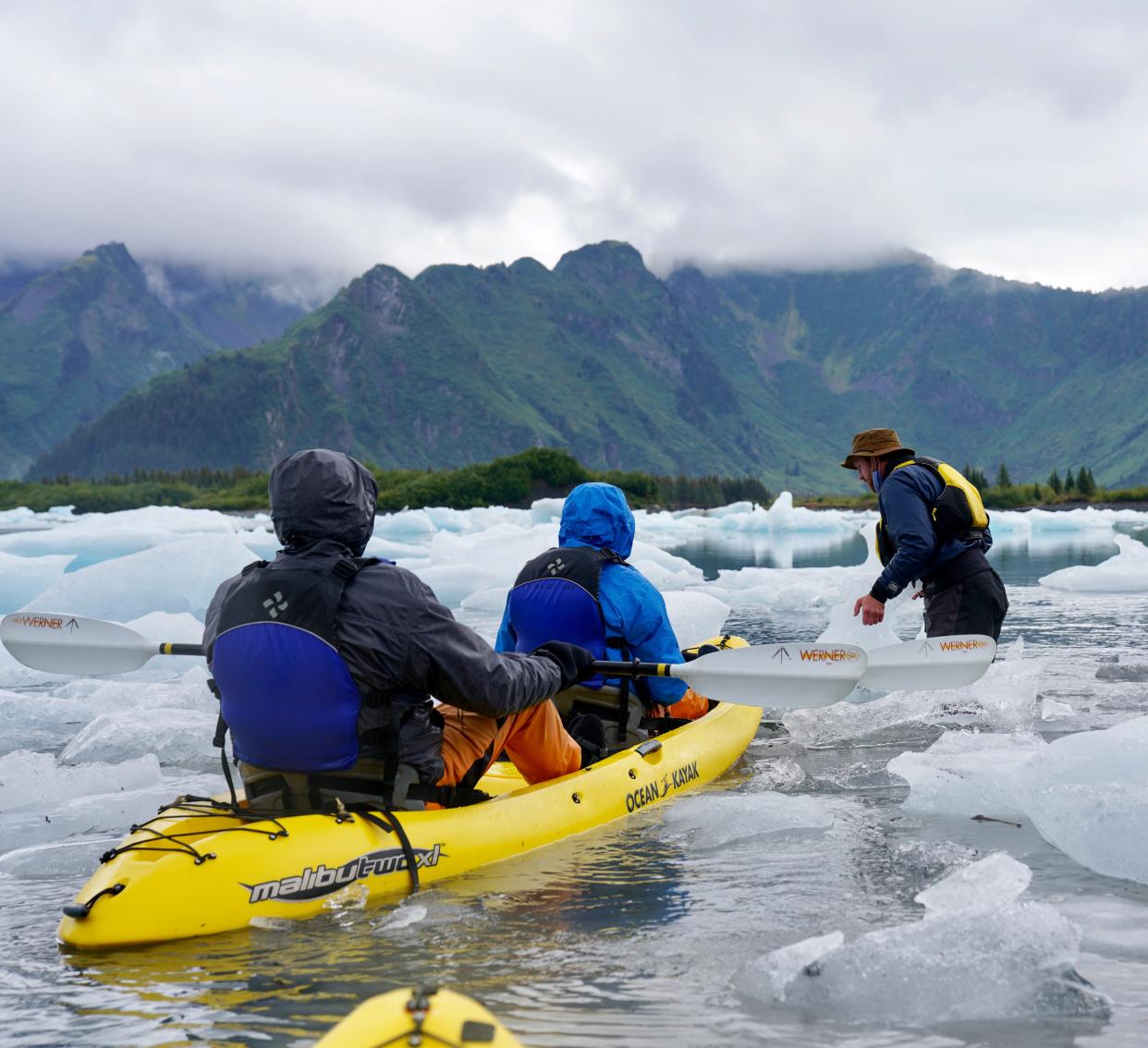 Kayakers paddle through icebergs in Alaska's Kenai Fjords National Park in September 2020.