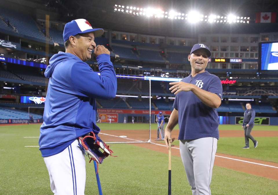 TORONTO, ON - APRIL 12: Manager Charlie Montoyo #25 of the Toronto Blue Jays meets with his former manager Kevin Cash #16 of the Tampa Bay Rays during batting practice before the start of a game between the Tampa Bay Rays and the Toronto Blue Jays action at Rogers Centre on April 12, 2019 in Toronto, Canada. (Photo by Tom Szczerbowski/Getty Images)