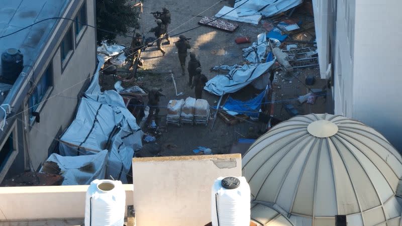 Israeli soldiers walk at Al Shifa hospital in Gaza City