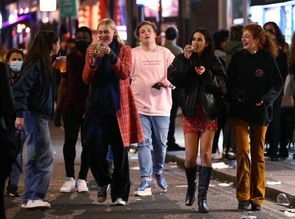 Revellers finish their drinks in the street after 10pm closing in London's Soho (PA)