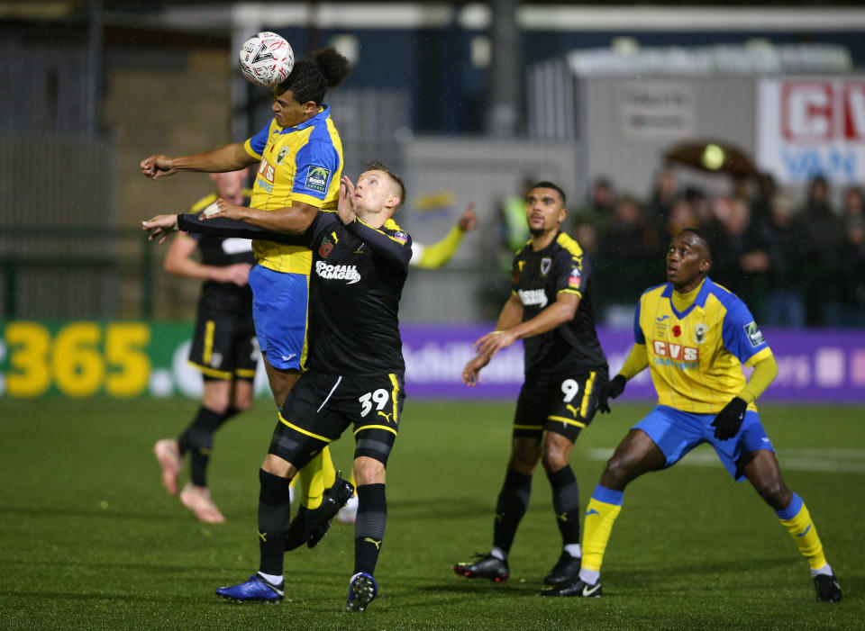 Haringey Borough's Coby Rowe (left) and AFC Wimbledon's Joe Pigott battle for the ball during the FA Cup first round match at the Coles Park Stadium, London. (Photo by Nigel French/PA Images via Getty Images)