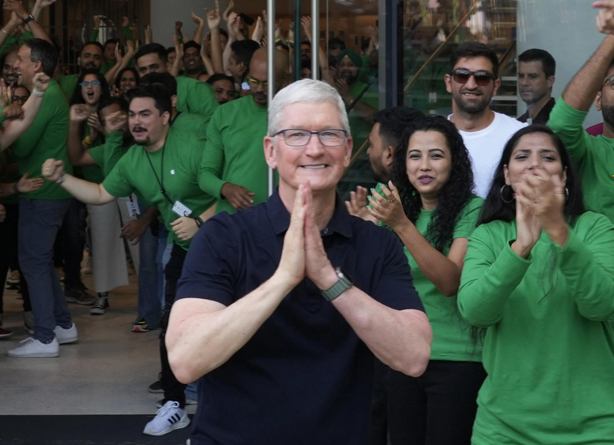 Apple CEO Tim Cook, center, greets people during the opening of the first Apple Inc. flagship store in Mumbai, India, Tuesday, April 18, 2023. Apple Inc. opened its first flagship store in India in a much-anticipated launch Tuesday that highlights the company's growing aspirations to expand in the country it also hopes to turn into a potential manufacturing hub. (AP Photo/Rafiq Maqbool)