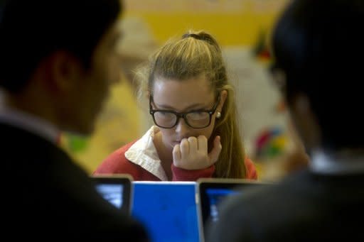 File photo shows a student using a computer. Facebook's big stock offering on Wall Street must be followed by an intensive debate on Main Street about social media's powerful impact on children, an expert on the topic says