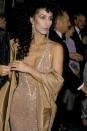 <p>If you thought all these other plunging necklines were low, Cher's is all the way down to her bellybutton! She arrived in this see-through gown and accessorized with statement earrings. </p>