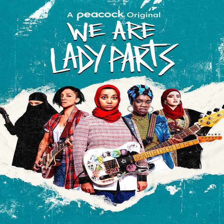 A group of Muslim girls, some in hijab, stand with instruments.