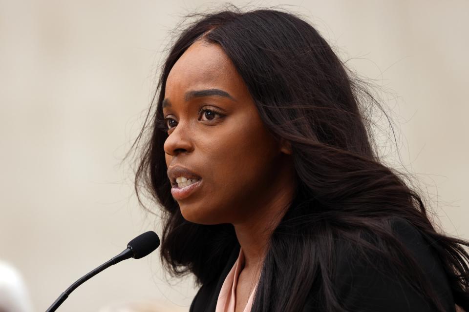 A woman speaks into a microphone