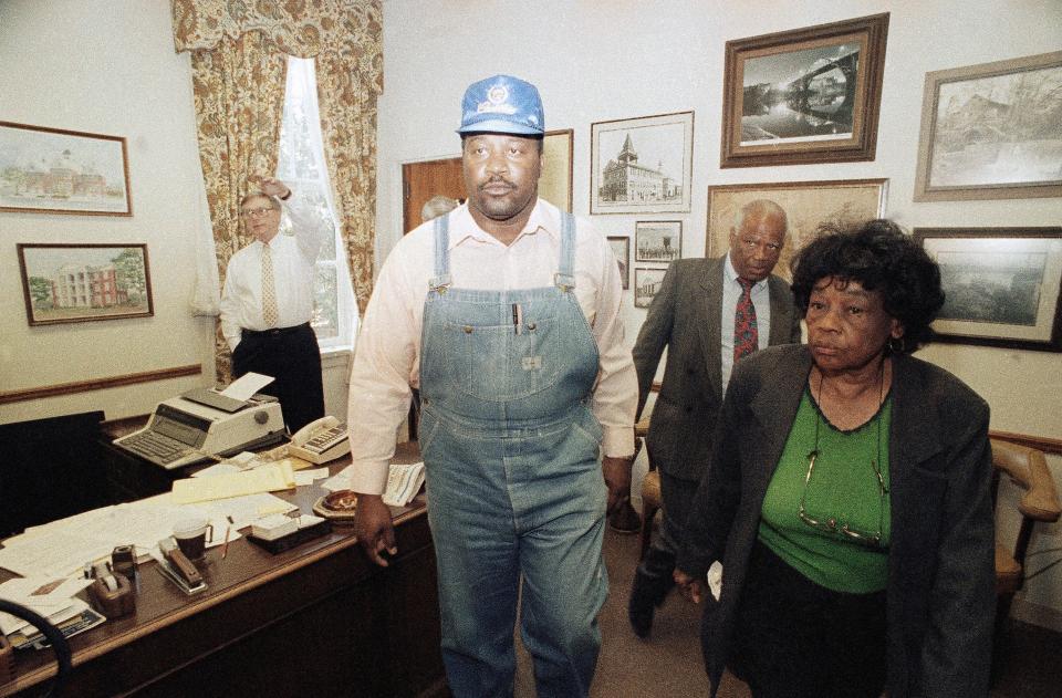 Leaders of a march to Selma's City Hall exit the mayor's office, Feb. 7, 1990. About 600 marchers gathered at the building to protest the leadership of the city's school system. From left: Selma Mayor Joe Smitherman, standing by window, and march leaders Ron Peoples, J.L. Chestnut and Marie Foster.