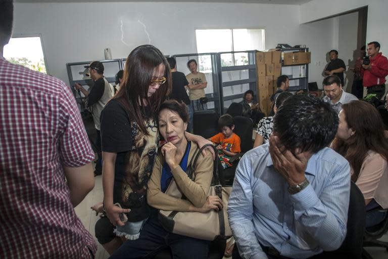 Relatives of passengers on board AirAsia flight QZ8501 gather at Juanda international airport in Surabaya in East Java, on December 28, 2014