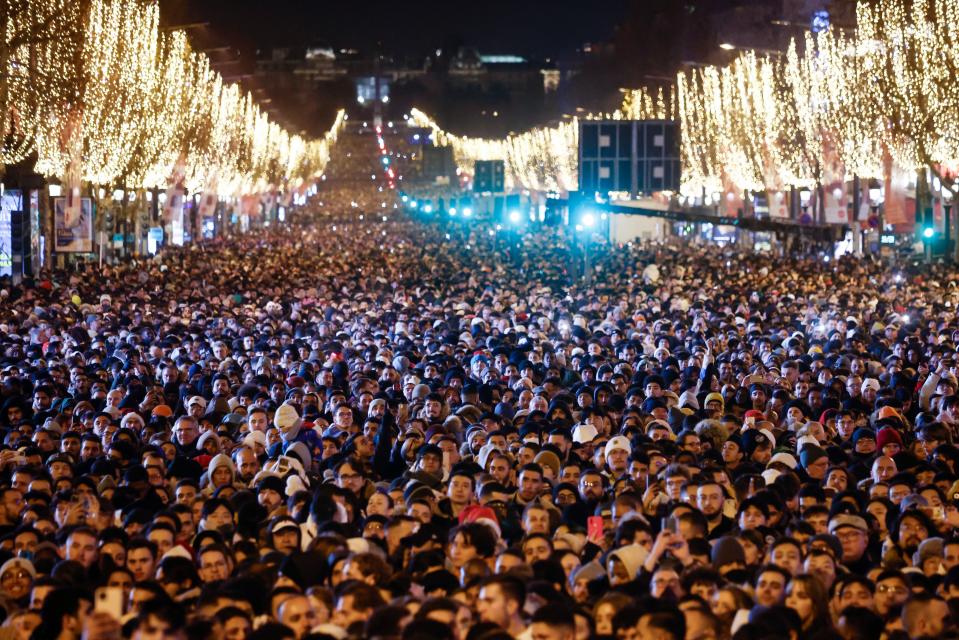 A large crowd gathers on the Champs Elysees to view a light show and fireworks near the Arc of Triomphe (EPA)