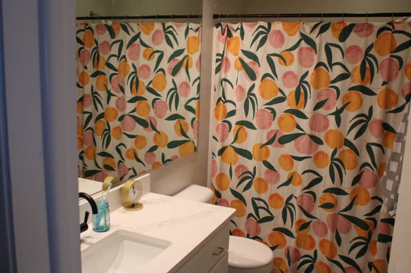 Peach shower curtain in a bathroom.