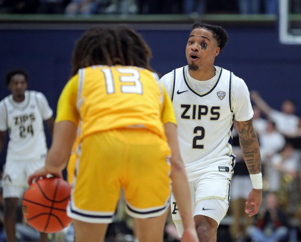 Akron Zips guard Greg Tribble (2) stares down Kent State Golden Flashes guard Jalen Sullinger (13) during the first half of an NCAA college basketball game, Friday, Feb. 23, 2024, in Akron, Ohio.