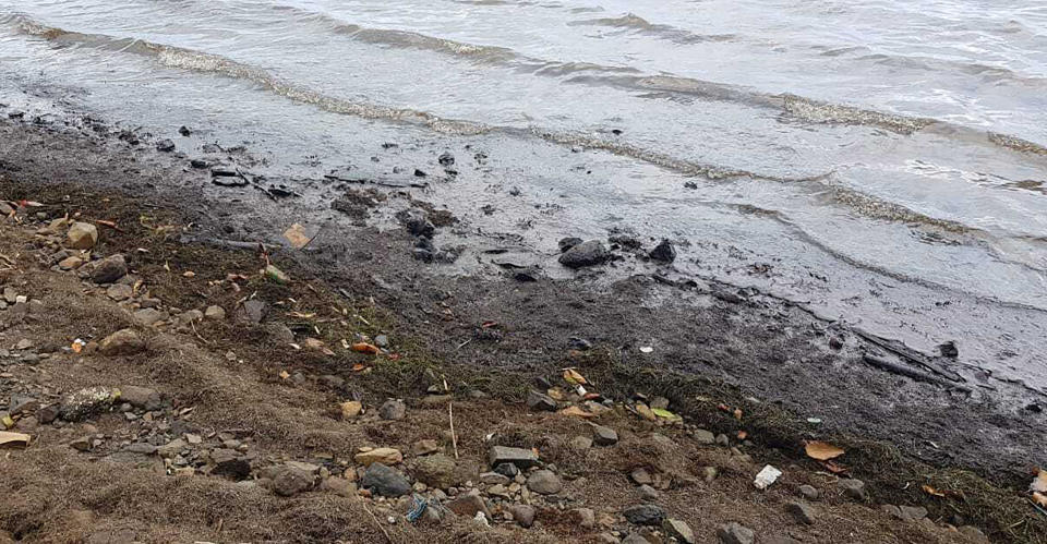 This photo taken and provided by Sunil Dowarkasing, showing oil polluting the foreshore on the eastern side of Mauritius, after it leaked from the MV Wakashio, a bulk carrier ship that recently ran aground off the southeast coast of Mauritius, Sunday, Aug. 9, 2020. Residents of the Indian Ocean island nation of Mauritius are stuffing fabric sacks with sugar cane leaves to create makeshift oil spill barriers as tons of fuel has leaked from a grounded ship. (Sunil Dowarkasing via AP)