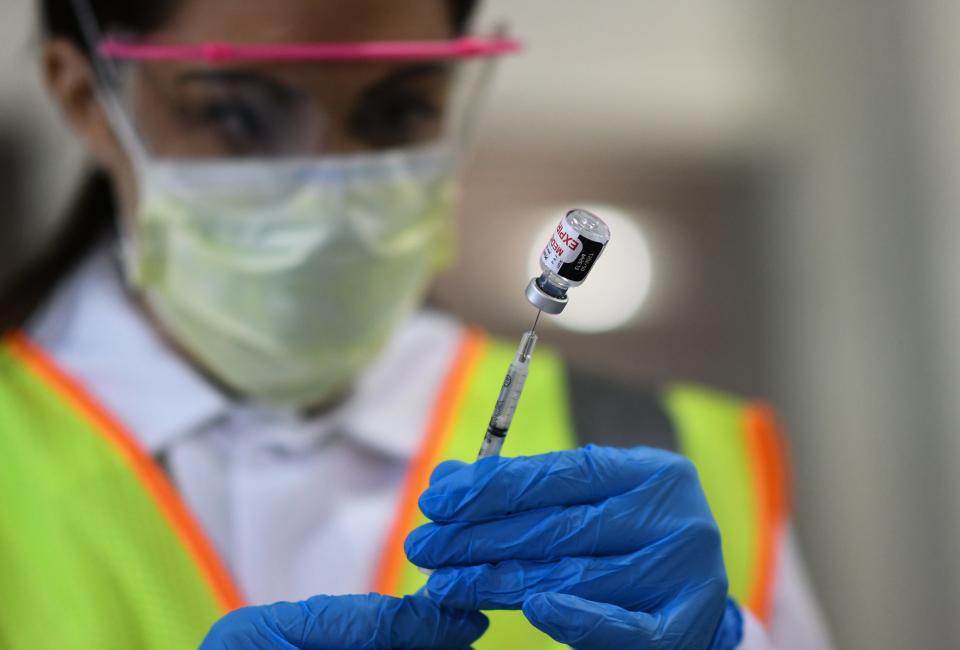 A registered nurse draws a shot, Tuesday, Jan. 19, 2021, at the Sparrow Laboratories Drive-Thru Services site in Lansing, the first day the hospital system made COVID-19 vaccine appointments available to people over 70 and to frontline essential workers.