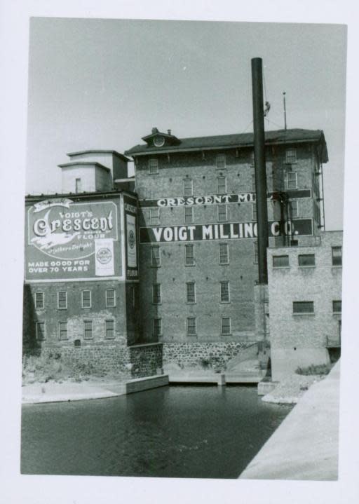 A historic photo of the old Voigt Mill along the Grand River in Grand Rapids. (Courtesy: Collections of the Grand Rapids Public Museum)