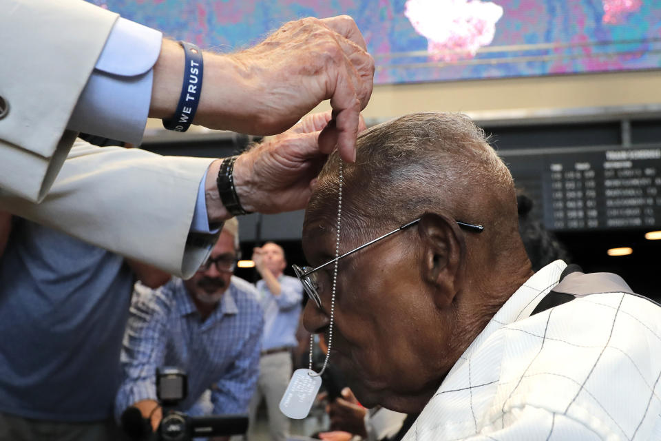 World War II veteran Lawrence Brooks receives a dog tag honoring whims the oldest living World War II veteran as he celebrates his 110th birthday at the National World War II Museum in New Orleans, Thursday, Sept. 12, 2019. Brooks was born Sept. 12, 1909, and served in the predominantly African-American 91st Engineer Battalion, which was stationed in New Guinea and then the Philippines during World War II. He was a servant to three white officers in his battalion. (AP Photo/Gerald Herbert)