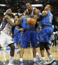 Memphis Grizzlies guard Mike Conley (11) is fouled as he attempts to shoot against Dallas Mavericks guards Monta Ellis (11) and Vince Carter on his way to the basket with 1.1 seconds left in overtime of an NBA basketball game Wednesday, April 16, 2014, in Memphis, Tenn. Conley scored at the free-throw line to win the game for the Grizzlies 106-105. (AP Photo/Lance Murphey)