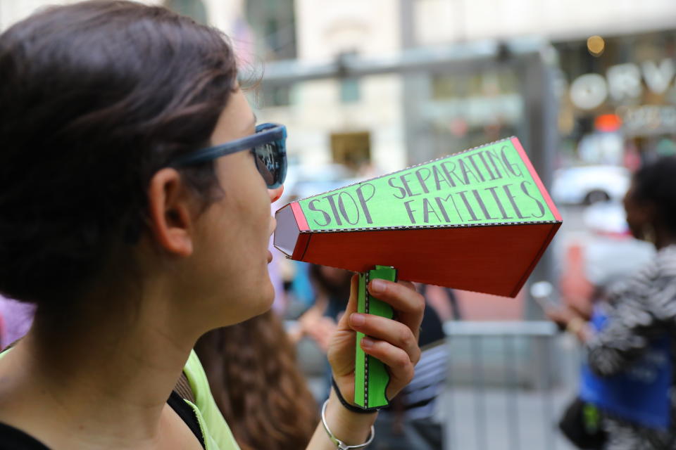 <p>A protester yells into a homemade megaphone during a protest outside the New York Public Library on 42nd Street in New York City on June 20, 2018. (Photo: Gordon Donovan/Yahoo News) </p>
