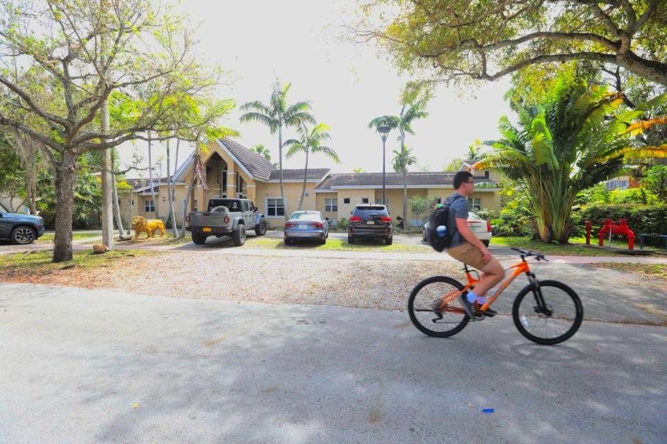 A person rides a bike in front of the Sigma Alpha Epsilon fraternity, 1520 Liguria Ave., near the University of Miami on Friday, March 1, 2024, in Coral Gables, Florida.