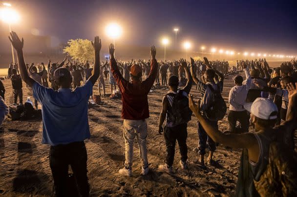 PHOTO: Immigrants pray while hoping to be processed by U.S. border agents for asylum after crossing over from Mexico on May 9, 2023, in El Paso, Texas. (John Moore/Getty Images)