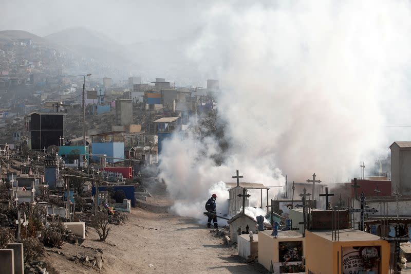 FILE PHOTO: A health worker sprays fumigation vapour to stem the spread of dengue virus in Lima