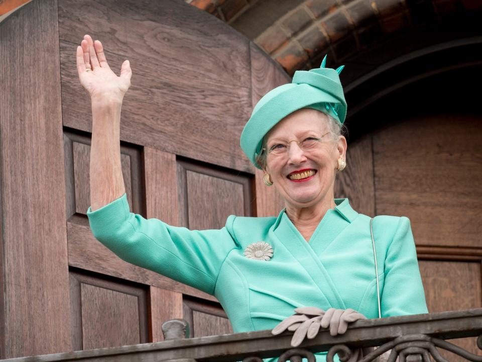 Queen Margrethe II of Denmark waves from the Town Hall balcony after lunch during festivities for her 75th birthday on April 16, 2015.