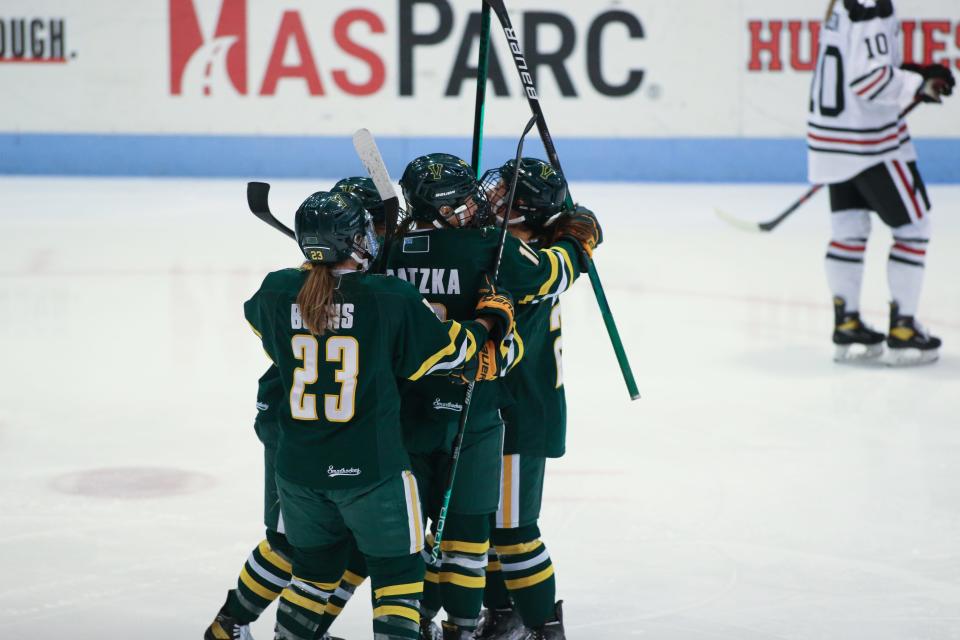 Vermont celebrates during the third period of a Hockey East matchup between Vermont and Northeastern at Matthews Arena. The Catamounts won the game 2-1 over the Huskies.