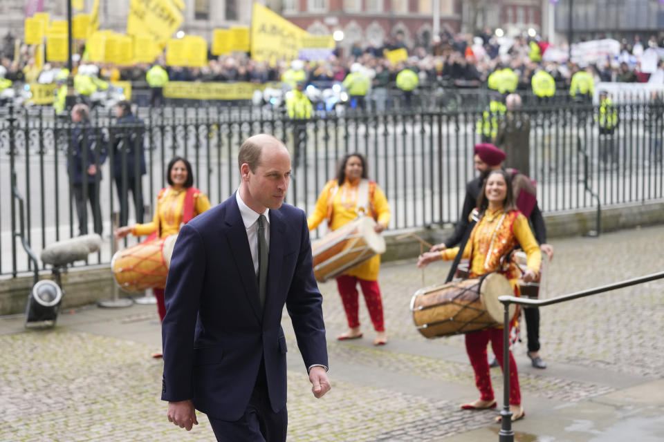 Prince William arrives to attend the annual Commonwealth Day Service of Celebration at Westminster Abbey in London, Monday, March 11, 2024. Commonwealth Day is an annual celebration observed by people all over the Commonwealth in Africa, Asia, the Caribbean and Americas, the Pacific and Europe. In the background is a demonstration by anti-monarchist protesters. (AP Photo/Kirsty Wigglesworth)