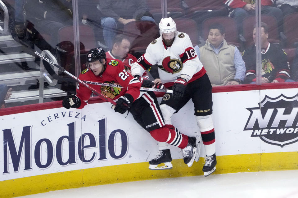 Ottawa Senators' Austin Watson (16) checks Chicago Blackhawks' Nikita Zaitsev against the boards during the second period of an NHL hockey game Monday, March 6, 2023, in Chicago. (AP Photo/Charles Rex Arbogast)