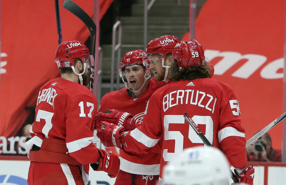 Detroit Red Wings right wing Anthony Mantha, second from right, celebrates his second-period goal against the Columbus Blue Jackets with defenseman Filip Hronek (17), center Dylan Larkin (71), and left-wing Tyler Bertuzzi (59) during an NHL hockey game Tuesday, Jan. 19, 2021, in Detroit. (AP Photo/Duane Burleson)